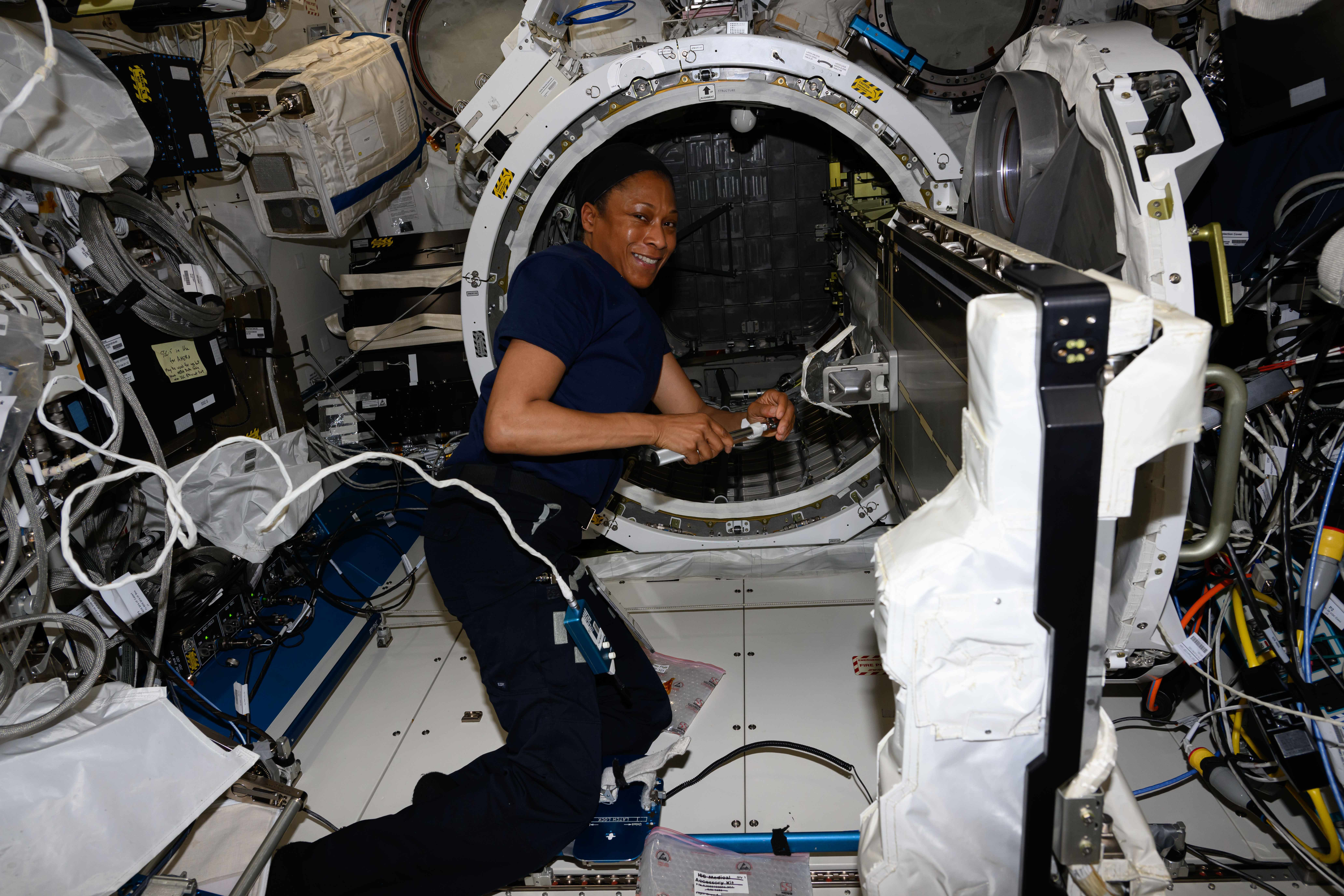 Expedition 71 Flight Engineer and NASA astronaut Jeanette Epps installs a small satellite orbital deployer inside the Kibo laboratory module’s ai...