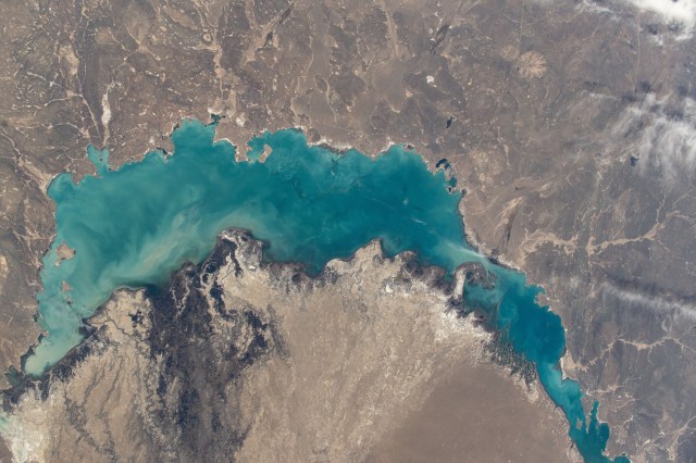 iss071e012112 (April 19, 2024) -- In southeastern Kazakhstan lies Lake Balkhash, one of the largest in Asia. Its turquoise color comes from winter ice melting. As the International Space Station soared nearly 260 miles above, NASA astronaut Mike Barratt captured this photo.