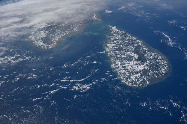 iss071e014023 (April 20, 2024) -- Sri Lanka, surrounded by the Indian Ocean, was photographed from the International Space Station as it orbited nearly 260 miles above. Spotted clouds lightly cover the country. Above it is Peninsular India, or South India.