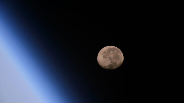 在国际空间站拍摄到的这颗渐衰的凸月位于地球地平线之上，它在日本东北部太平洋上空258英里的轨道上运行。