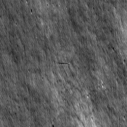 grayscale view of lunar surface with a smeared streak in the center of the image