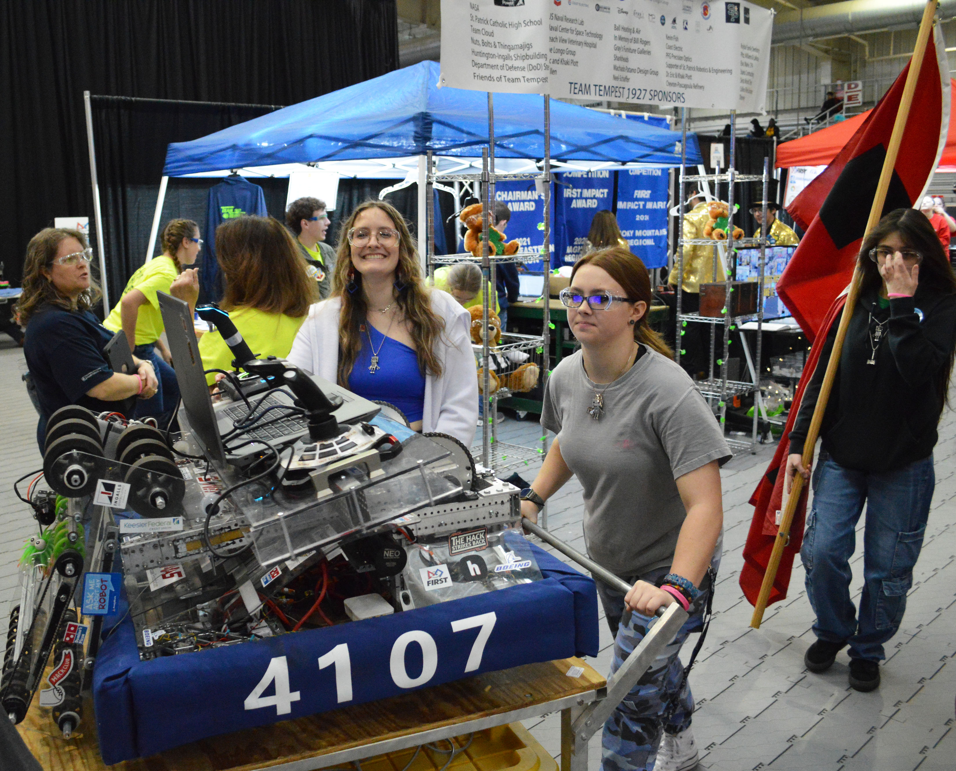 Participants wheel their robot onto the floor