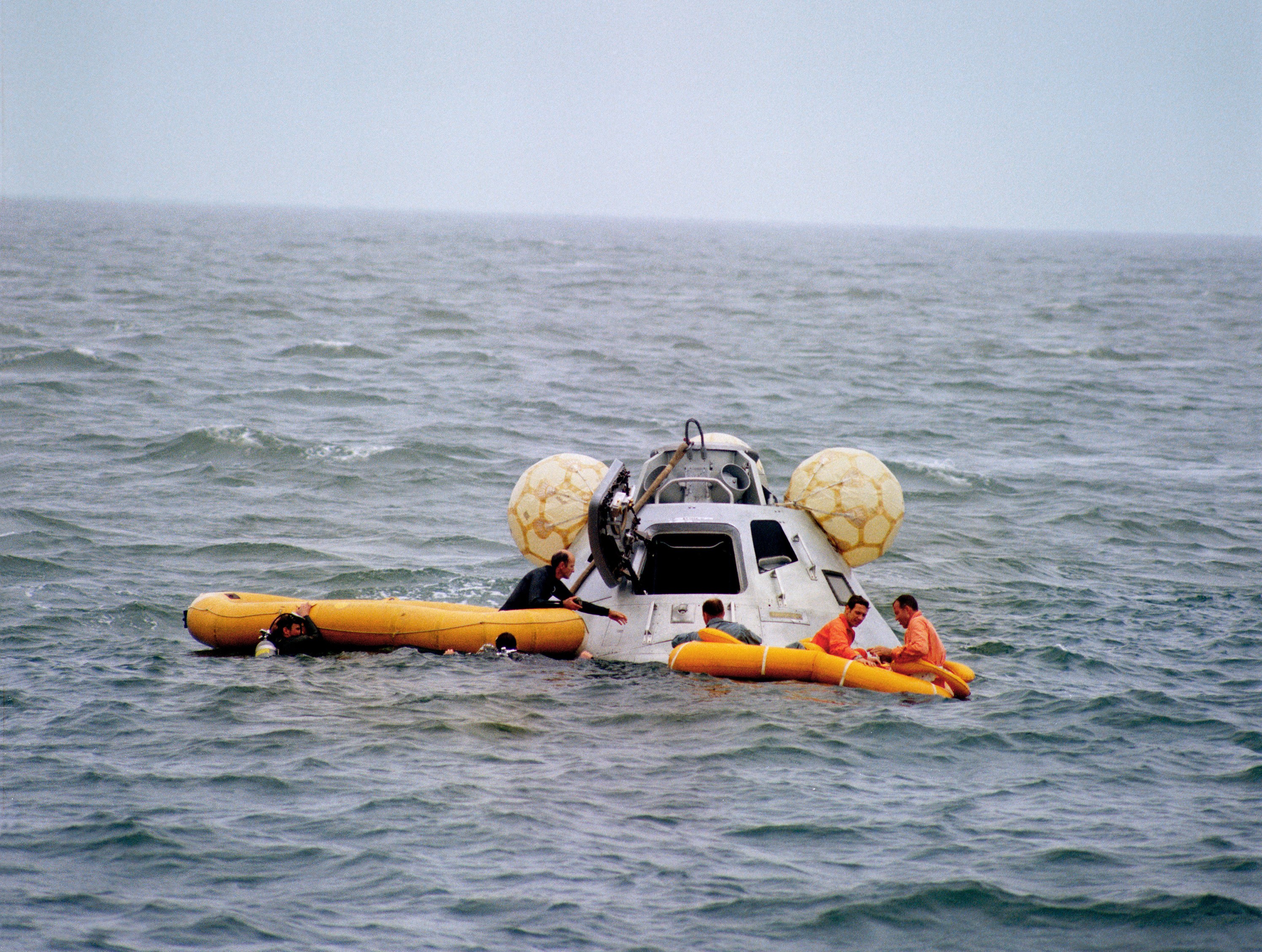Mitchell, left, Eisele, and Cooper in the life raft await pickup by a helicopter during the water egress test
