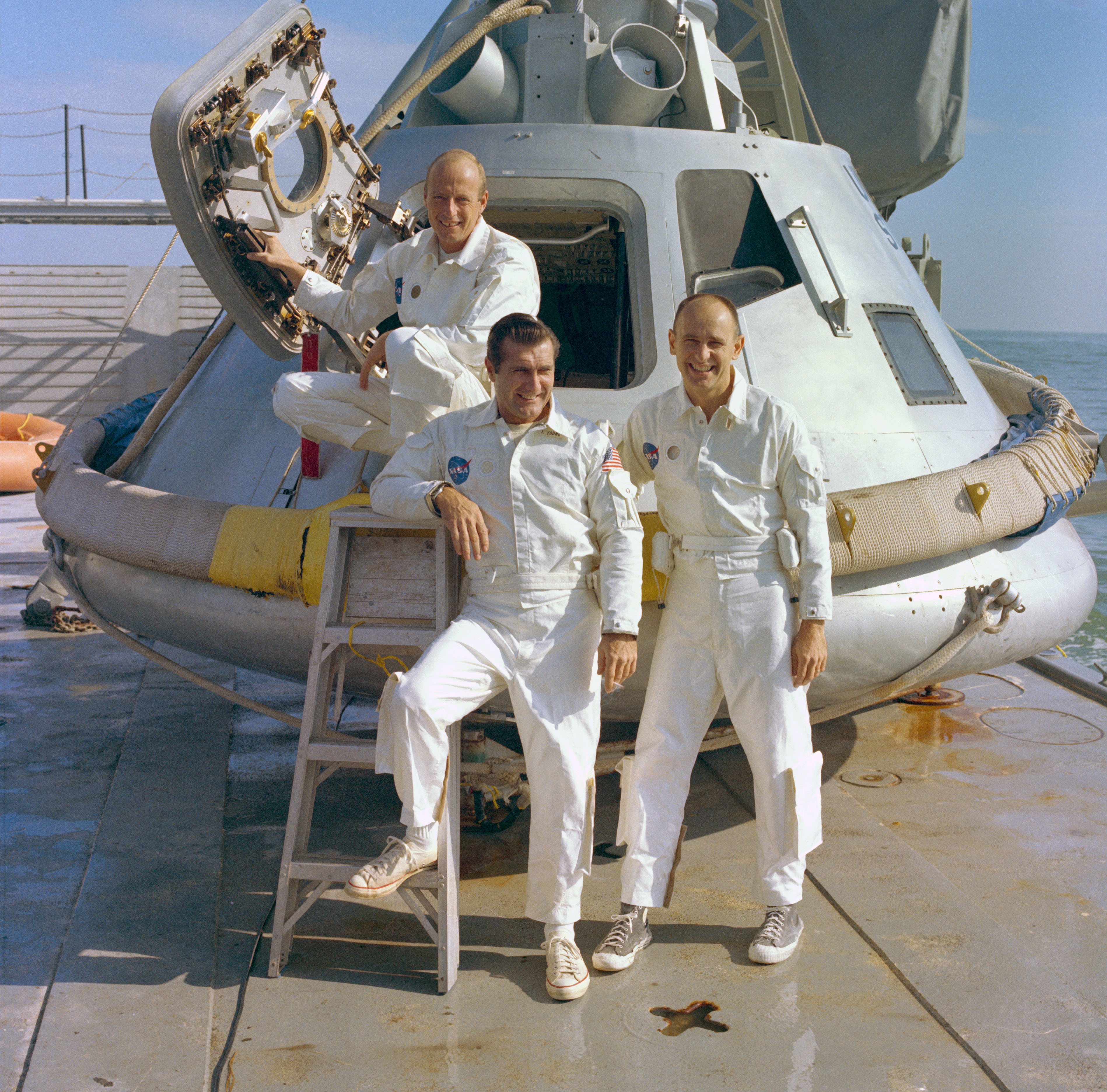 Apollo 12 astronauts Charles “Pete” Conrad, left, Richard F. Gordon, and Alan L. Bean pose in front of a boilerplate Apollo capsule during water egress training when they served as the backup crew for Apollo 9