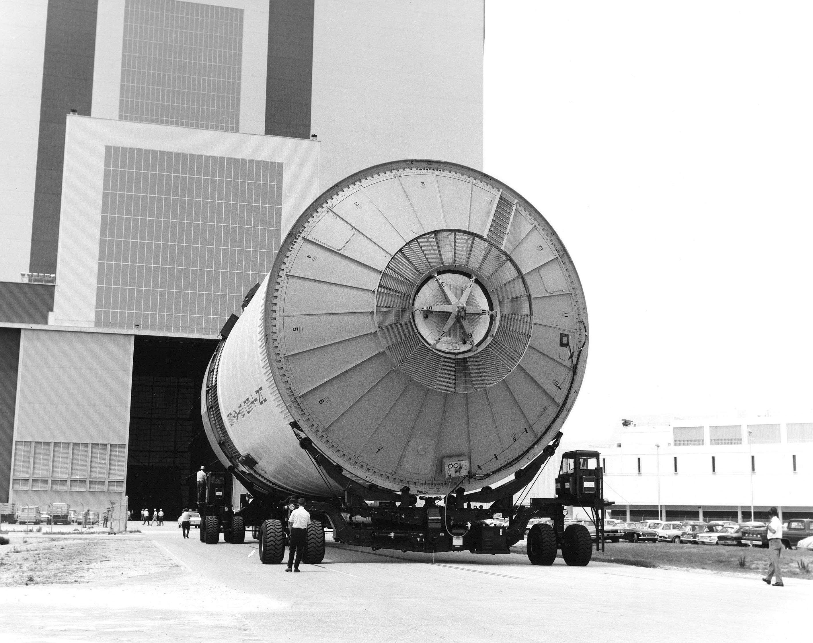 Workers roll the Apollo 12 Saturn V S-II second stage into KSC's Vehicle Assembly Building