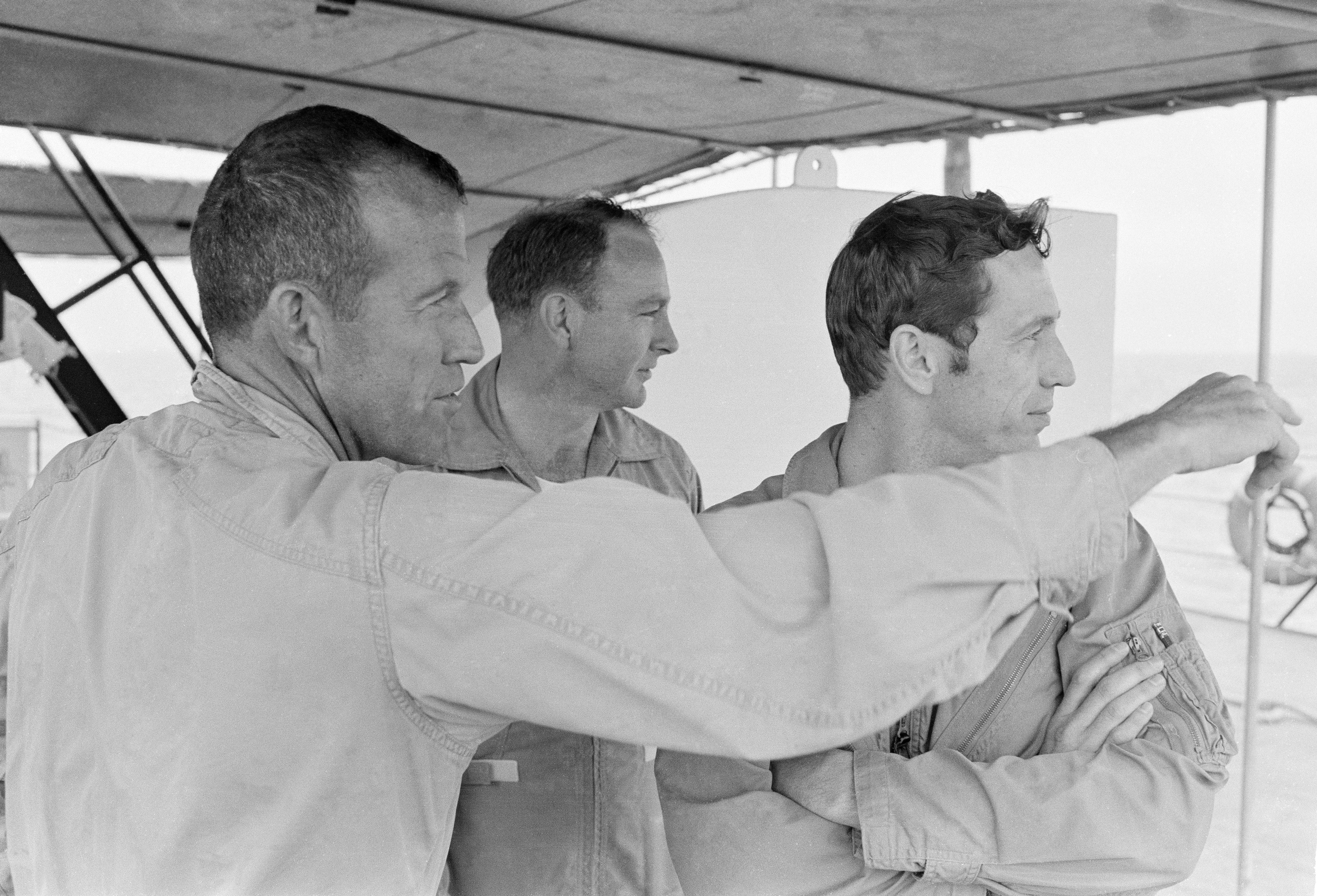 The Apollo 10 backup crew of L. Gordon Cooper, left, Edgar D. Mitchell, and Donn F. Eisele prepare for the water egress test aboard the MV Retriever in the Gulf of Mexico