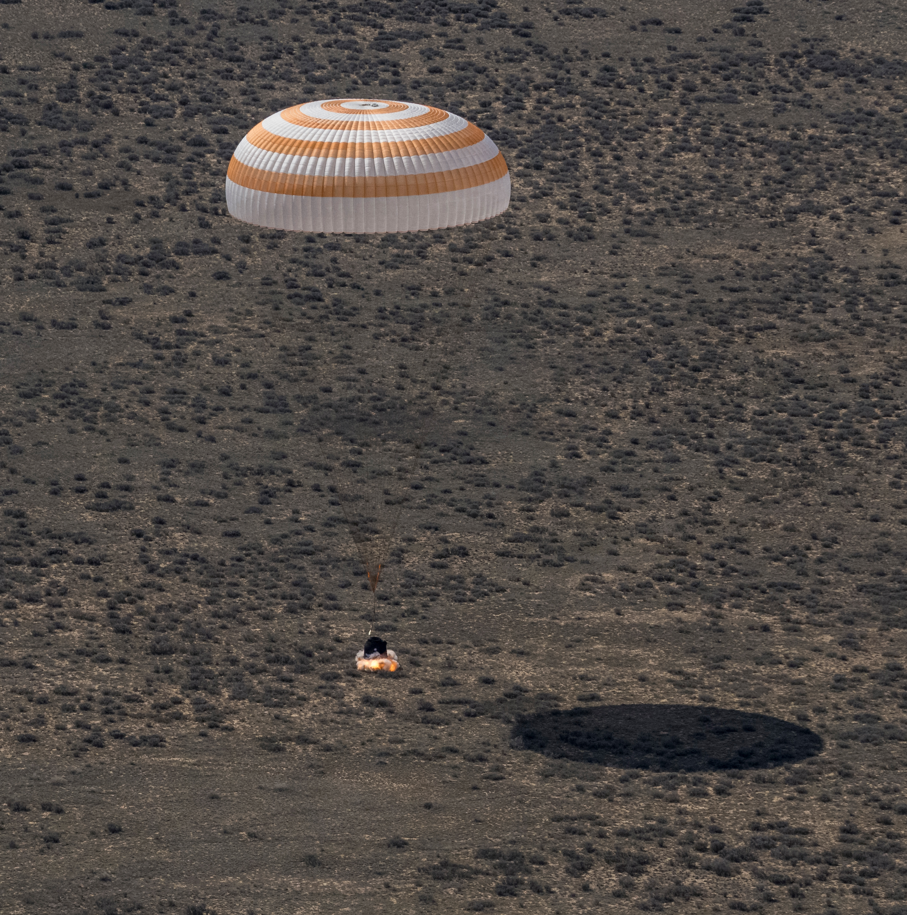 The Soyuz MS-24 spacecraft lands near the town of Zhezkazgan, Kazakhstan, under its main parachute on Saturday, April 6, 2024. The Soyuz crew ship fired its soft-landing engines a split second before landing to soften the impact of touching down on the Earth's surface. Aboard the Soyuz crew ship were NASA astronaut Loral O'Hara, Roscosmos cosmonaut Oleg Novitskiy, and Belarus spaceflight participant Marina Vasilevskaya who had undocked from the International Space Station several hours earlier. Credit NASA/Bill Ingalls