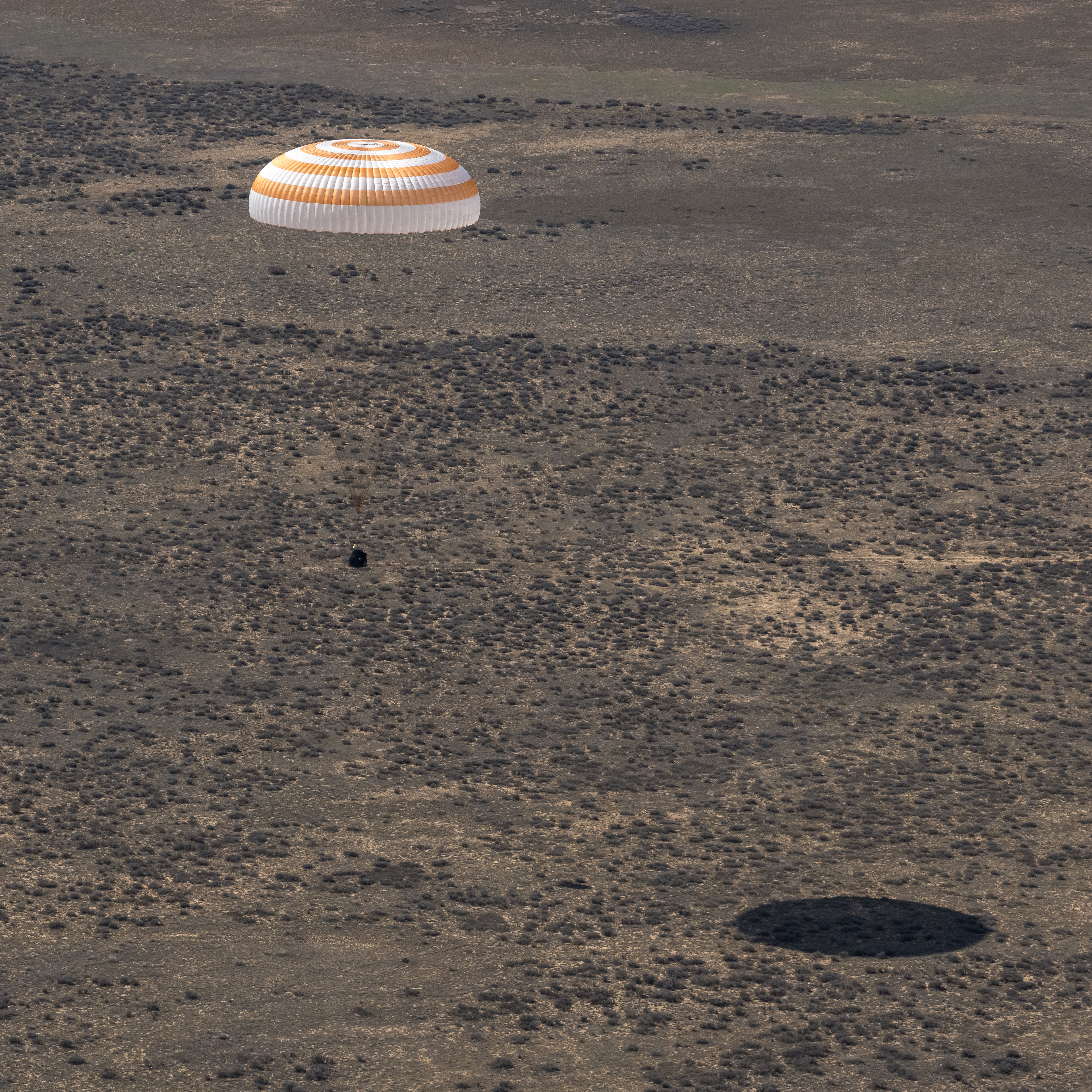 The Soyuz MS-24 spacecraft descends to Earth under its main parachute near the town of Zhezkazgan, Kazakhstan, on Saturday, April 6, 2024. Aboard the Soyuz crew ship were NASA astronaut Loral O'Hara, Roscosmos cosmonaut Oleg Novitskiy, and Belarus spaceflight participant Marina Vasilevskaya who had undocked from the International Space Station several hours earlier. Credit NASA/Bill Ingalls