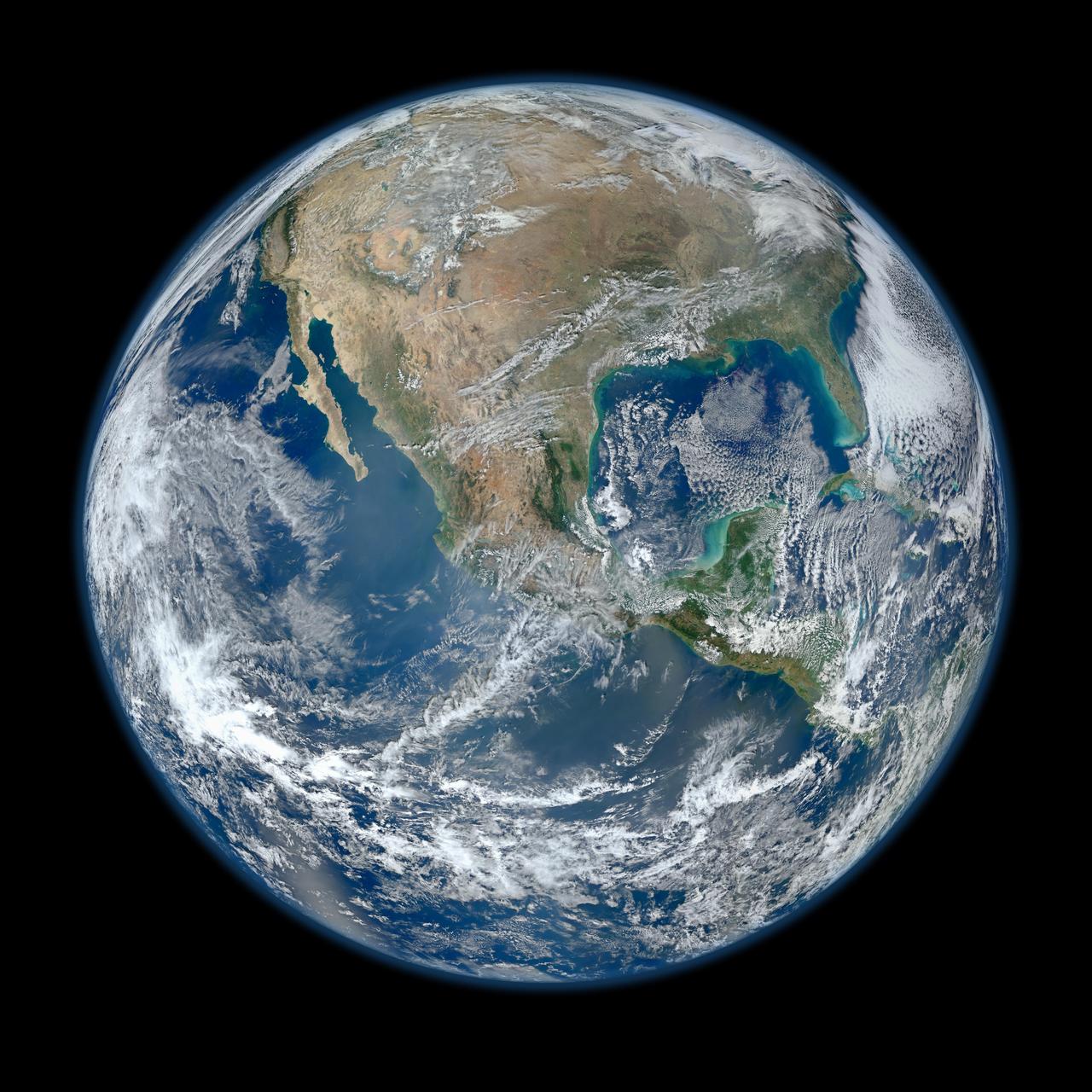 North America is visible in this image of Earth. Clouds swirl all over the globe, and much of Earth's water is visible.