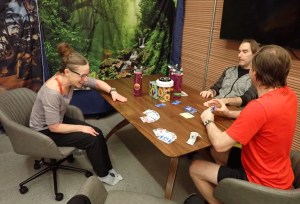 From left, Kelly Haston, Nathan Jones, and Ross Brockwell are pictured playing a card game inside the CHAPEA habitat. Credit: NASA