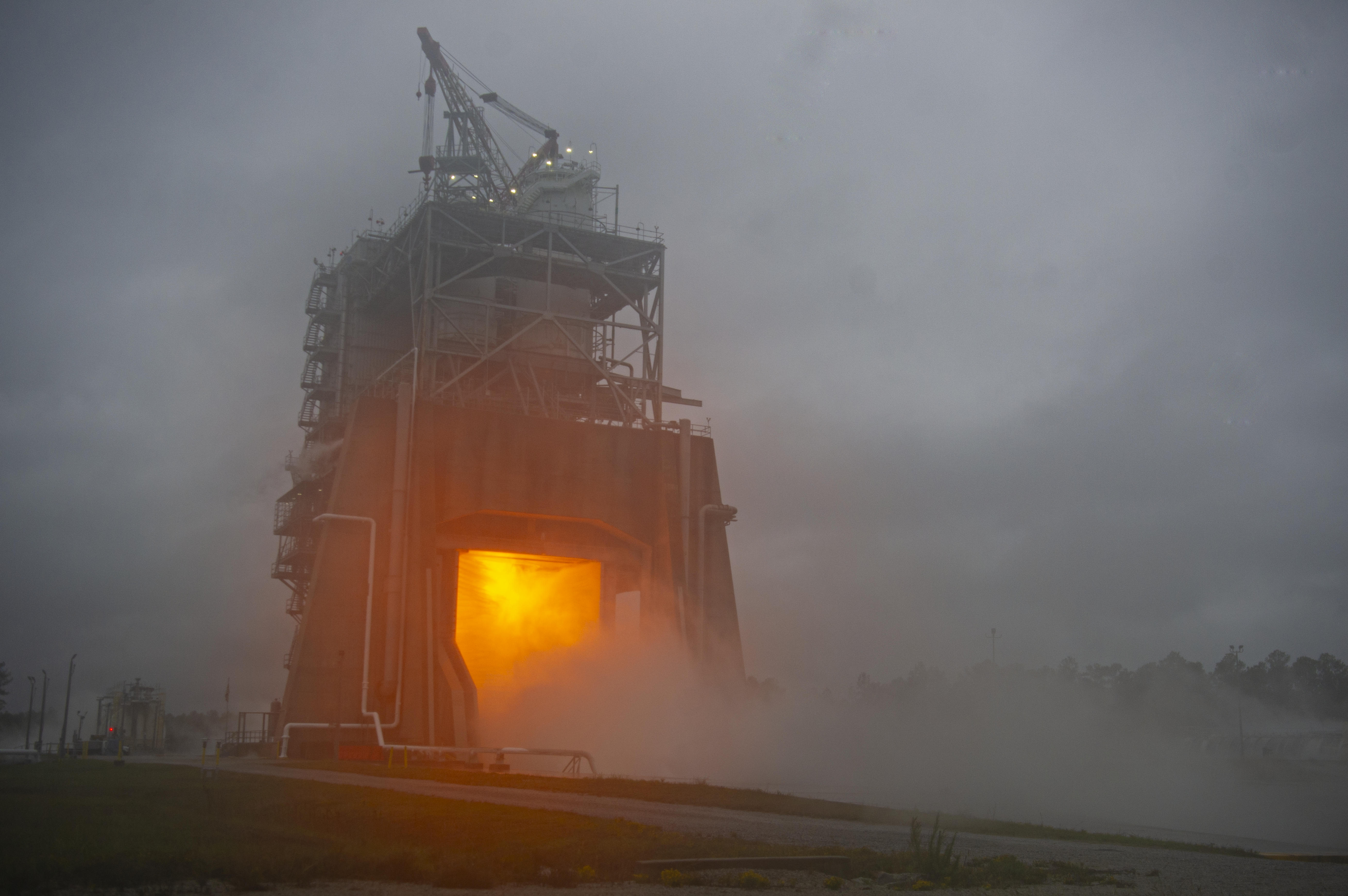 a fire burns brightly as the operators power up the RS-25 engine