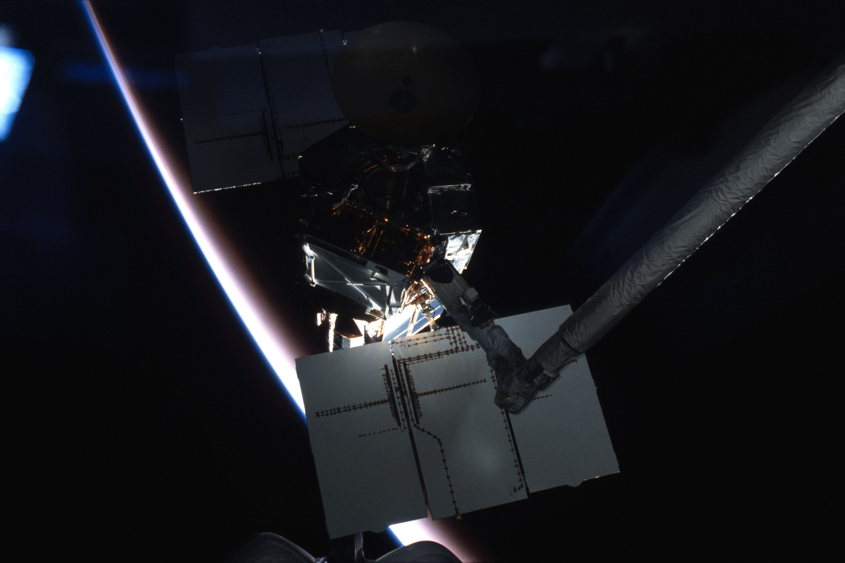 Terry J. Hart grapples Solar Max during orbital night