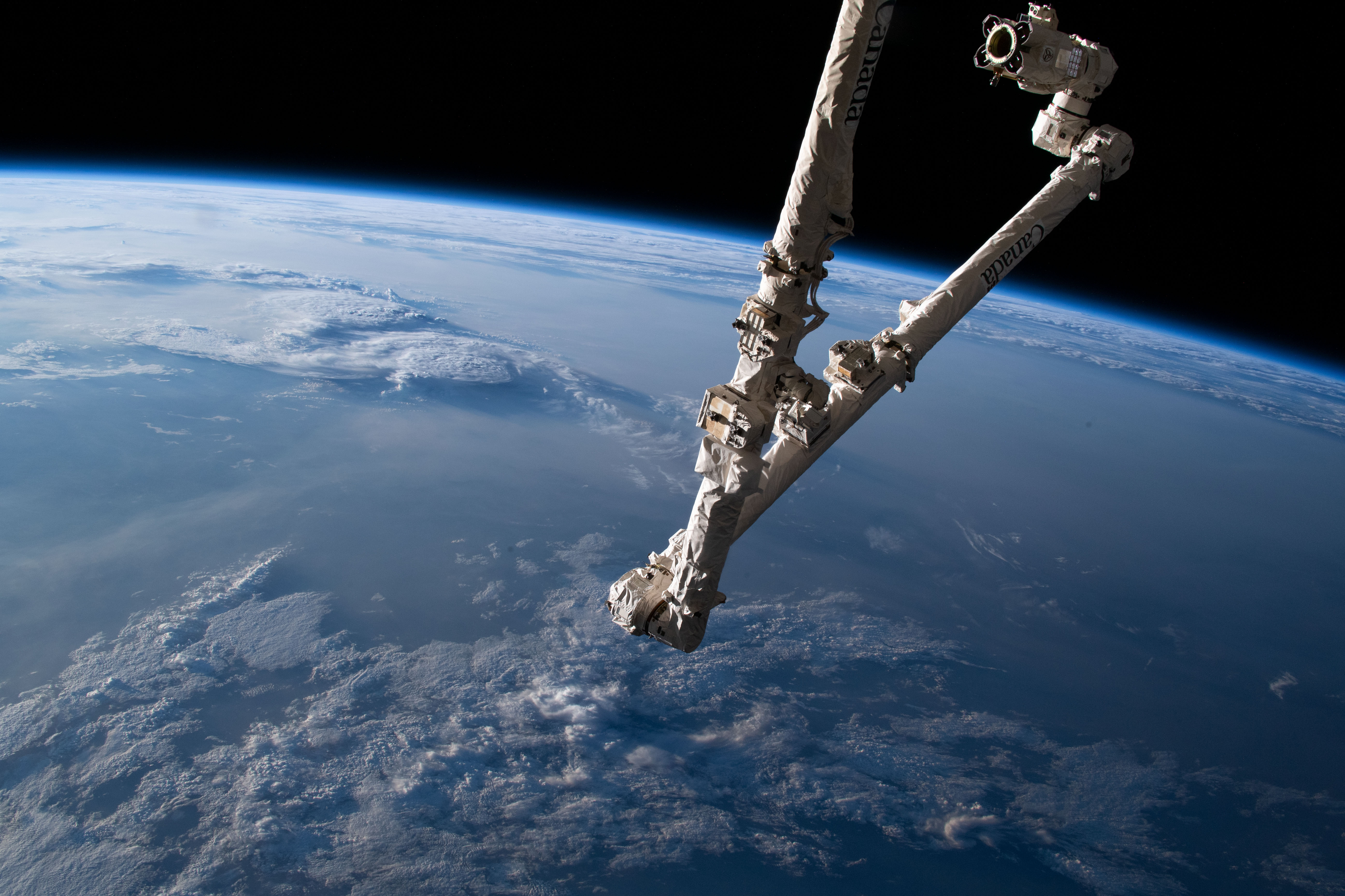 iss060e007297 (July 12, 2019) --- The Canadarm2 robotic arm is positioned for upcoming training activities ahead of the arrival and capture of the SpaceX Dragon cargo craft. The International Space Station was orbiting 257 miles over Mongolia when an Expedition 60 crewmember took this photograph.