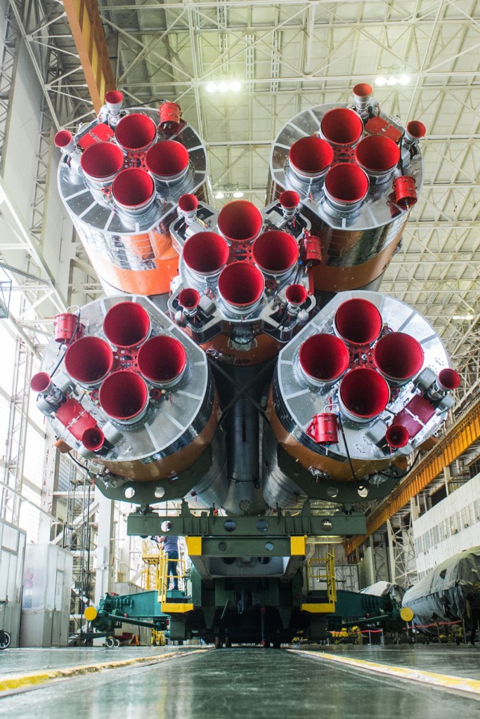jsc2019e039432 (July 16, 2019) --- In the Integration Building at the Baikonur Cosmodrome in Kazakhstan, the first stage engines of the Soyuz booster are prominent in the field of view July 16 as final preparations begin for the launch of three new crewmembers to the International Space Station. Drew Morgan of NASA, Alexander Skvortsov of Roscosmos and Luca Parmitano of the European Space Agency will launch July 20 on the Soyuz MS-13 spacecraft from the Baikonur Cosmodrome for a mission on the International Space Station. Credit: Andrey Shelepin/GCTC