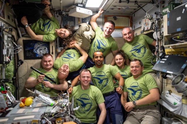iss060e080784 (Sept. 26, 2019) --- The nine International Space Station residents pose for a portrait inside the Zvezda service module. At the bottom row from left are, station cosmonaut Alexey Ovchinin, astronauts Luca Parmitano and Nick Hague, visiting astronaut Hazzaa Ali Almansoori of the United Arab Emirates, astronaut Jessica Meir and cosmonaut Oleg Skripochka. At the top are, astronauts Christina Koch and Andrew Morgan with cosmonaut Alexander Skvortsov.