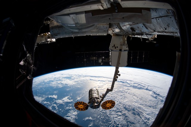iss060e022993 (Aug. 6, 2019) --- The Cygnus resupply spacecraft from Northrop Grumman is shown grappled by the Canadarm2 robotic arm following its detachment from the Unity module and just before release. Behind the robotic arm, the SpaceX Dragon is seen still attached to the Unity module of the International Space Station.