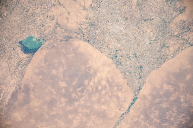 iss060e000604 (June 26, 2019) --- The Murghab river flows into the oasis city of Mary in the Karakum Desert in Turkmenistan. At left, is the Hanhowuz Reservoir which plays an important role in agriculture in southeastern Turkmenistan. The International Space Station was orbiting 256 miles above the Central Asian nation when this photograph was taken.