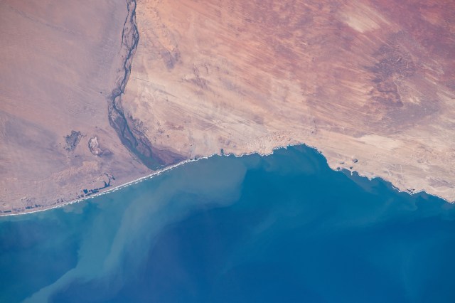 iss060e006420 (July 10, 2019) --- The Orange River separates the nations of Namibia and South Africa as it flows into Alexander Bay on the edge of the Atlantic Ocean. The International Space Station was on a southeastern orbital trek 262 miles above the African continent when an Expedition 60 crewmember captured this Earth observation.