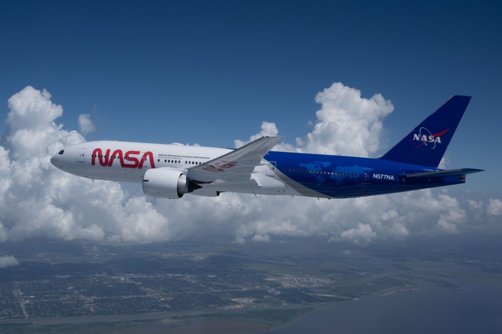 NASA's Boeing 777 flies through the clouds with a fresh red, white, and blue NASA paint job.