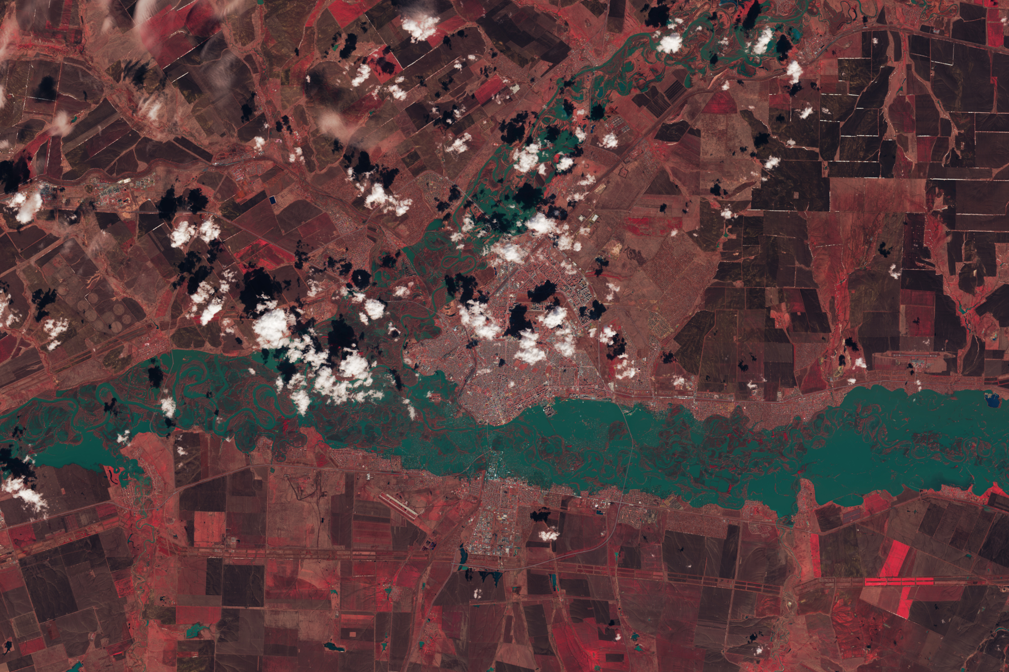 An enhanced color image of Orenburg, Russia when the Ural River water levels peaked. Vegetation is a deep red, while water is blue green.