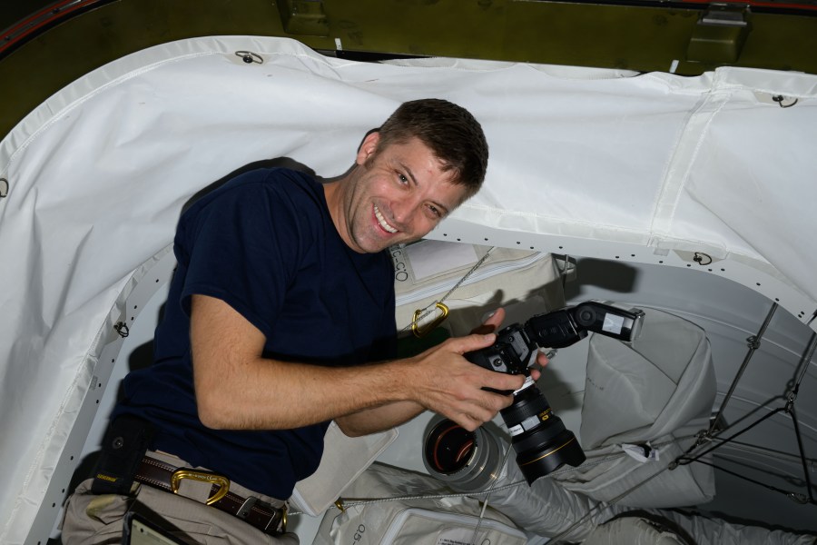 Expedition 70 Flight Engineer and NASA astronaut Matthew Dominick smiles for a portrait during photography duties aboard the International Space Station.