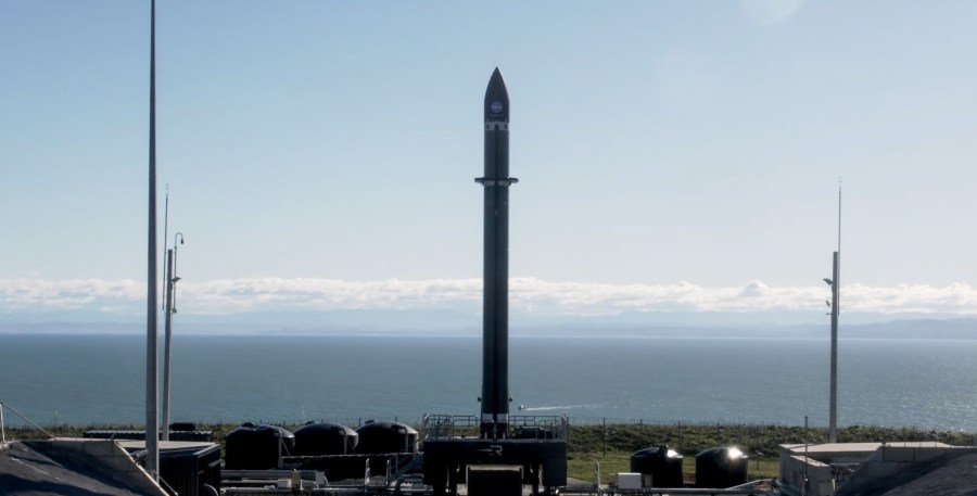 A Rocket Lab Electron rocket is erect on the launch pad.
