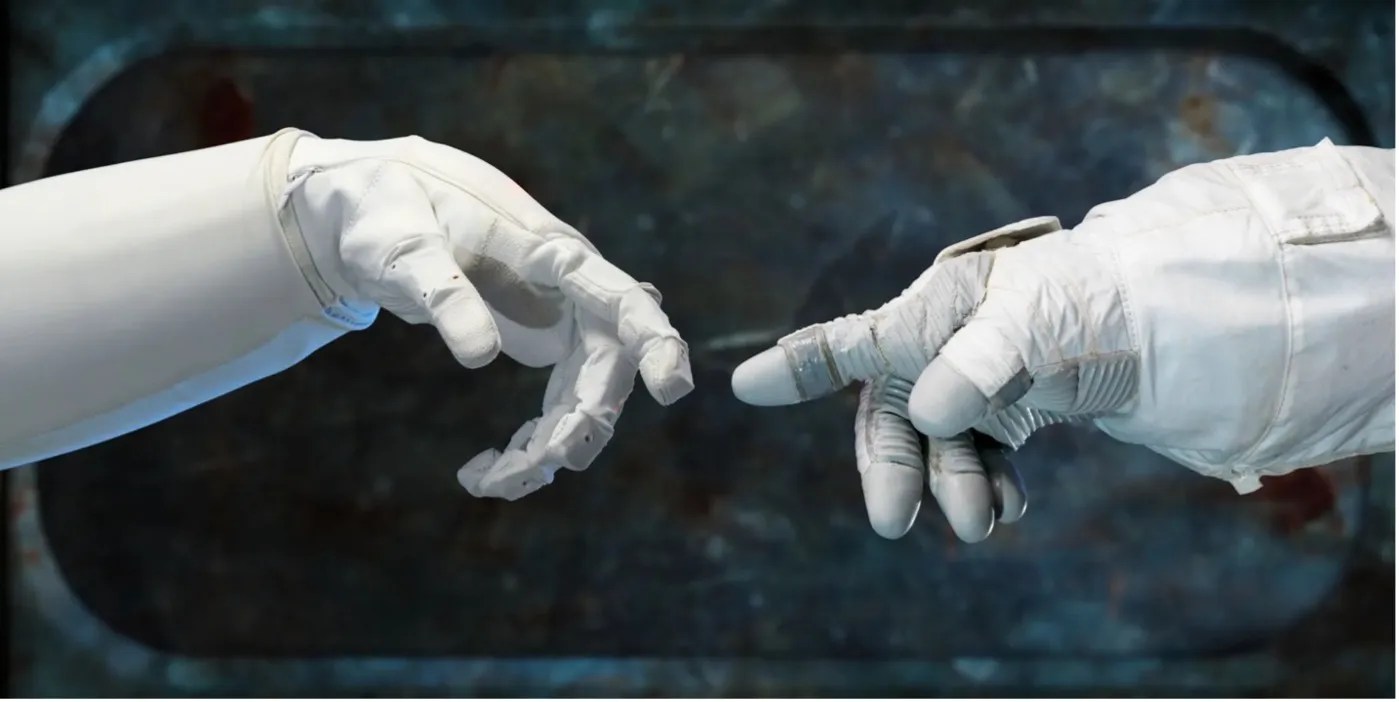 A robot hand touches an astronaut's gloved hand.