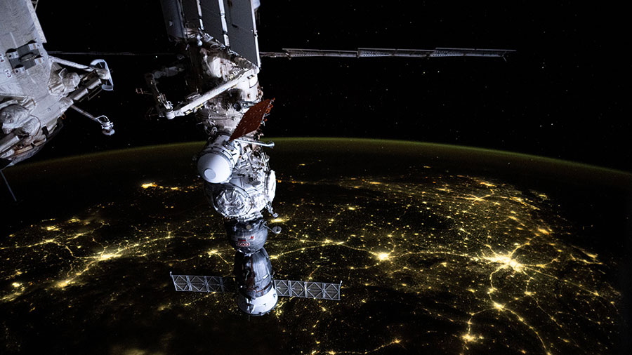 An atmosphreric glow blankets Earth's horizon and a web of city lights interconnect across India in this photograph from the space station.