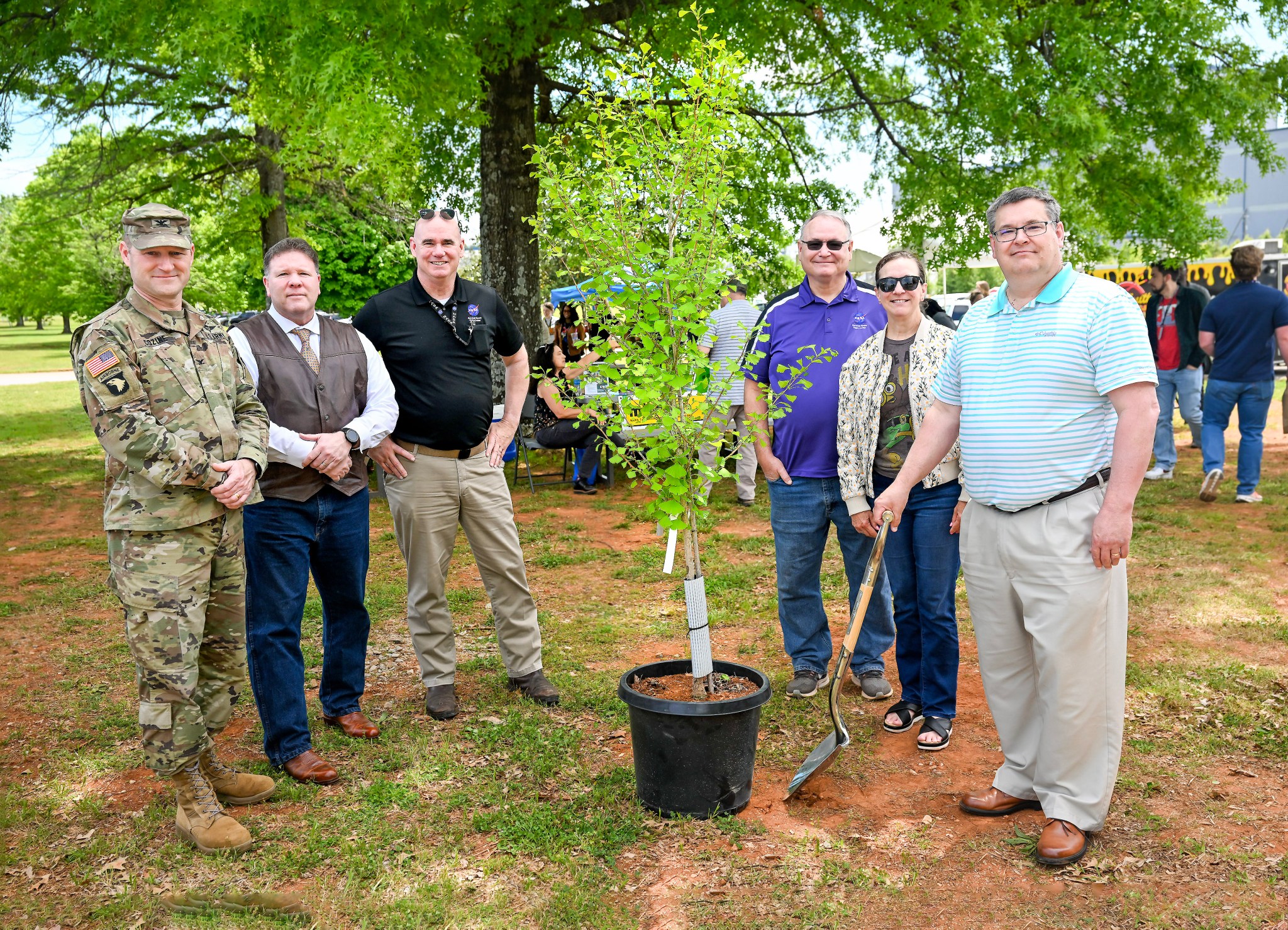 Redstone Arsenal and Marshall Space Flight Center leaders stand beside a carefully selected Ginkgo tree during Earth Day activities April 25 at Marshall’s food truck corral. The “Autumn Gold” Ginkgo will grow behind the Medical Center at Building 4249 as a living reminder of Marshall’s commitment to sustainability and environmental stewardship. From left, Redstone Arsenal Garrison Commander Col. Brian Cozine; Deputy Garrison Commander Martin Traylor; Deputy Director of Marshall’s Office of Center Operations Bill Marks; Environmental Engineering and Occupational Health Manager Farley Davis; Director of Center Operations June Malone; and Associate Center Director, Technical, Larry Leopard.