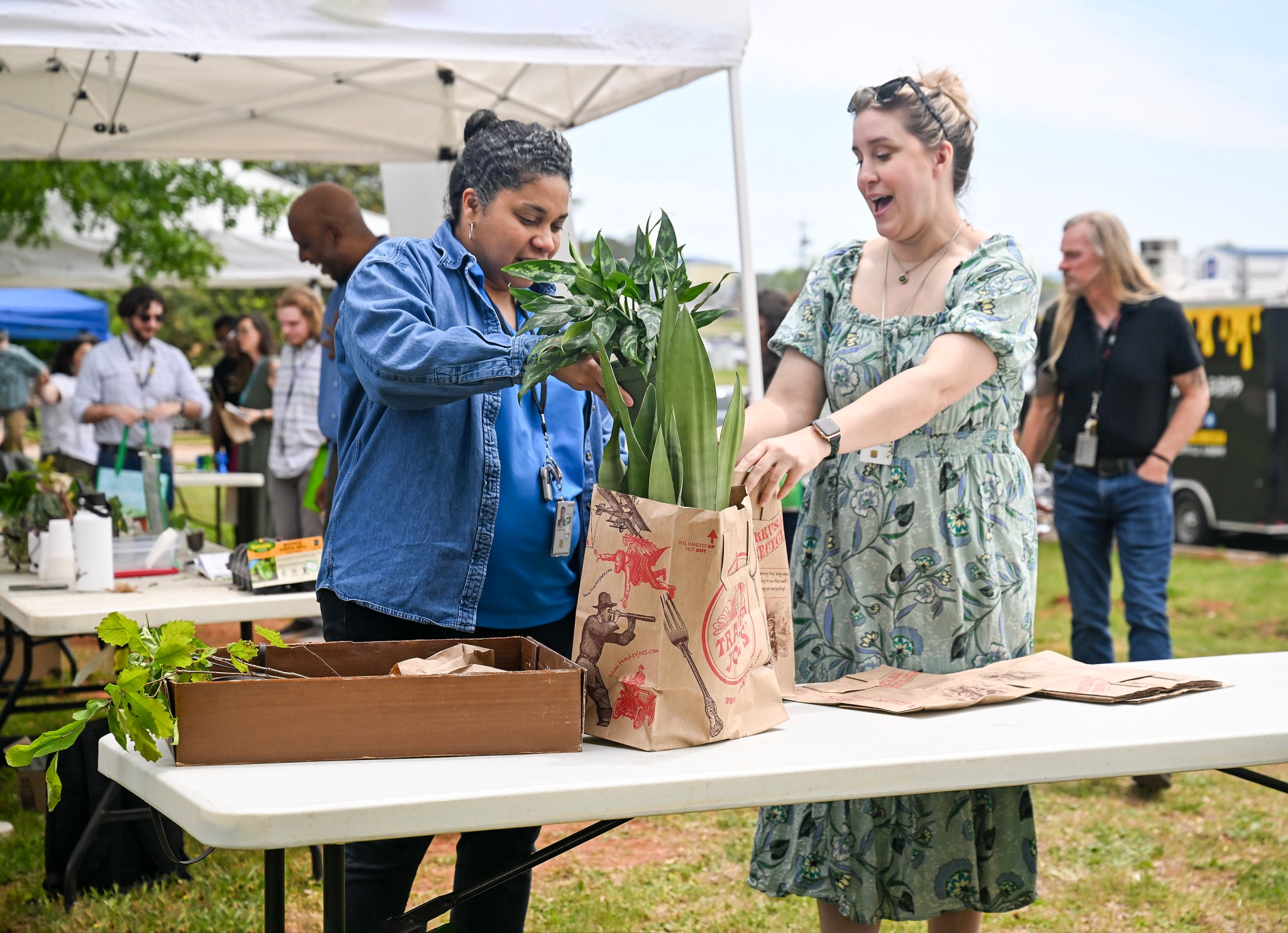 Environmental Protection Specialist Joni Melson, right, lends a helping hand to a fellow plant lover at Marshall’s Earth Day celebration April 25. Melson led Marshall’s planning and coordination for the event, a joint effort with Team Redstone.