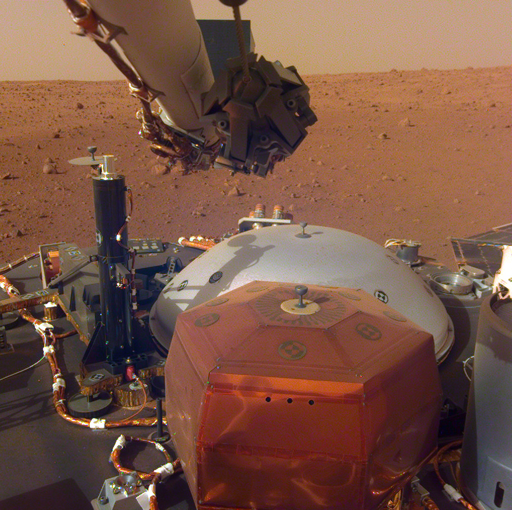 The Seismic Experiment for Interior Structure instrument (SEIS) aboard NASA’s Mars InSight is within the copper-colored hexagonal enclosure in this photo taken by a camera on the lander’s robotic arm on Dec. 4, 2018. The SEIS technology is being used on Farside Seismic Suite, bound for the Moon.