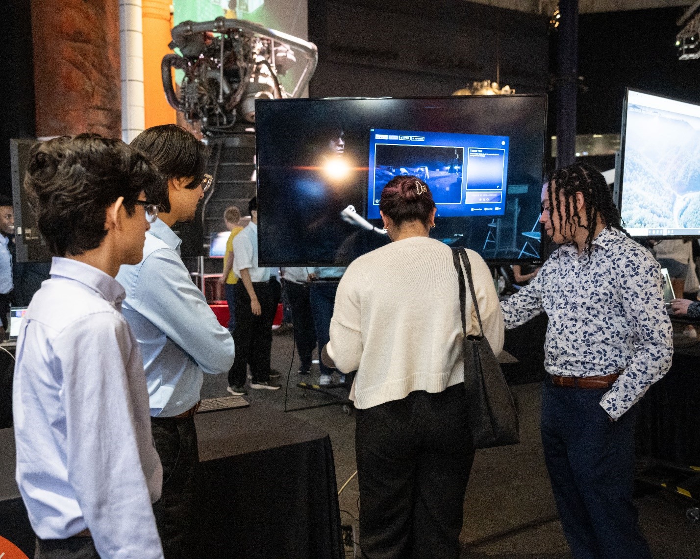 Student team members of FrostByte, a 2024 App Development Challenge top team from North High School in Des Moines, Iowa, explain their computer application for exploring the lunar surface to members of the public at Space Center Houston.