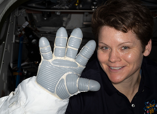 Astronaut Ann McClain displays a spacesuit glove