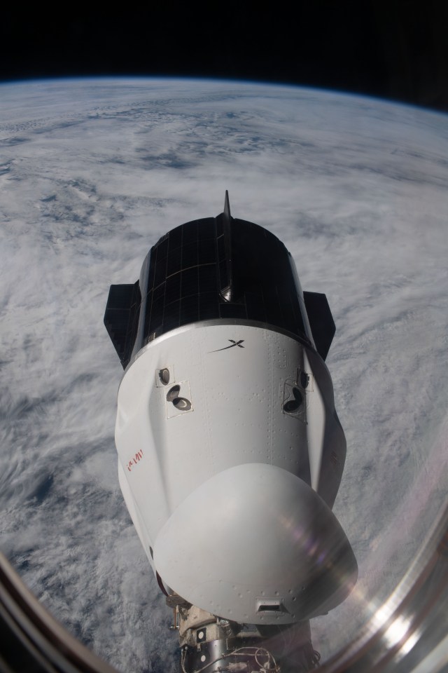 The SpaceX Dragon Endeavour spacecraft is pictured docked to the International Space Station's forward port on the Harmony module as the orbital complex soared 269 miles above a cloudy South Atlantic Ocean.