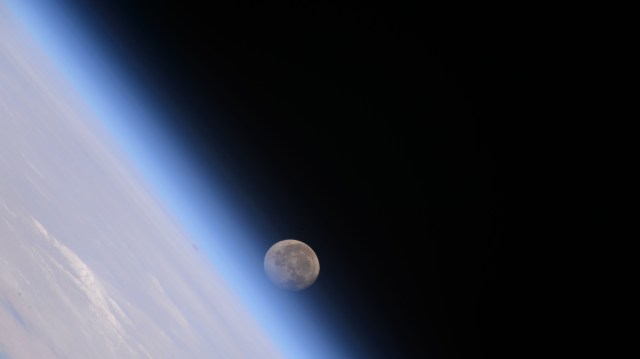 The waning gibbous Moon begins setting below Earth's horizon in this photograph from the International Space Station as it orbited 258 miles above China.