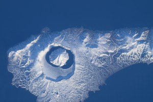 iss071e046421 (April 29, 2024) -- In the north end of the Kuril island chain is Onekotan, an uninhabited volcanic island, home to Krenitsyn volcano, pictured here from the International Space Station as it orbited 260 miles above. The volcano rises 900 meters (~3,000 feet) at its highest point and surrounding it is Tao-Rusyr Caldera.