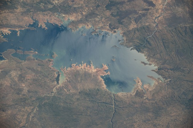 Lake Kariba, the world's largest artifical lake by volume, sits in between the nations of Zambia (top) and Zimbabwe in this photograph from the International Space Stataion as it orbited 260 miles above the African continent.