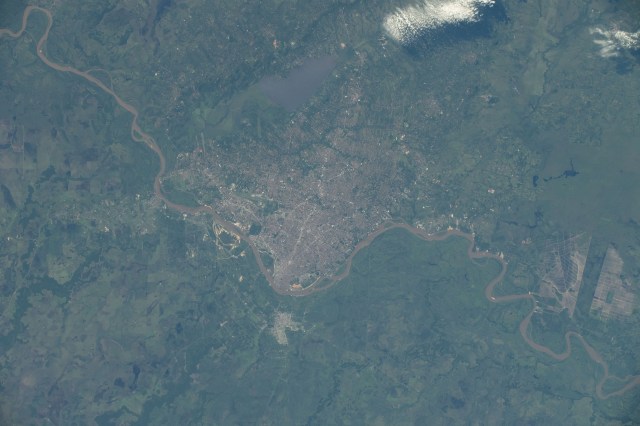 Asunción, the capital city of Paraguay on the Paraguay River, and its suburbs across the border from Argentina are pictured from the International Space Station as it orbited 261 miles above South America.