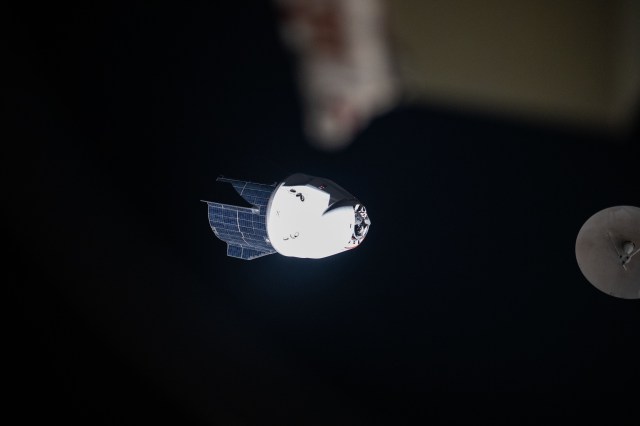 The SpaceX Dragon Endeavour spacecraft backs away from the International Space Station. Dragon switched ports moving from the Harmony module's forward port to its space-facing port during the relocation maneuver.