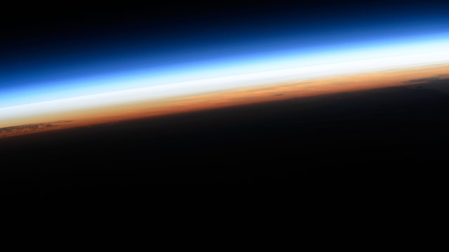 The last rays of an orbital sunset illuminate Earth's atmosphere in this photograph from the International Space Station as it orbited 259 miles above the Pacific Ocean.