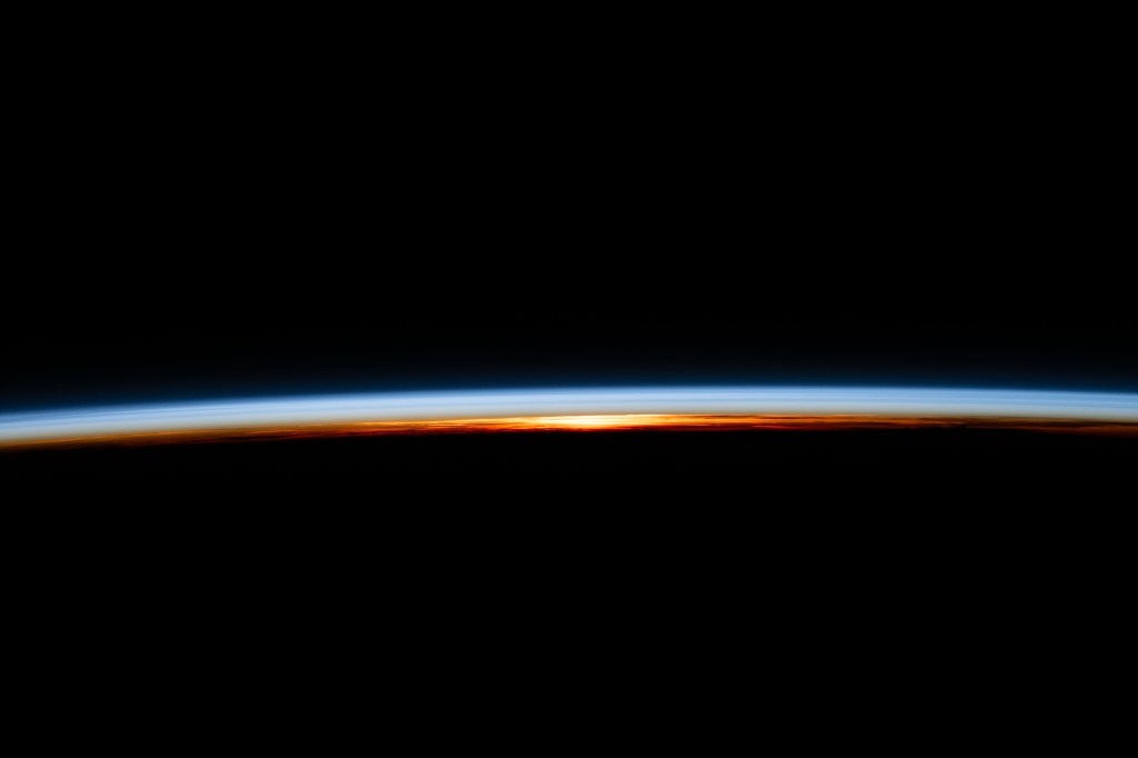 The last rays of an orbital sunset illuminate Earth's atmosphere and reveal the cloud tops in this photograph from the International Space Station as it orbited 258 miles above the Atlantic Ocean.