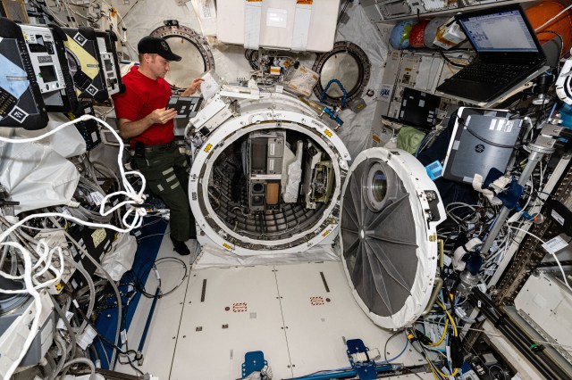 NASA astronaut and Expedition 71 Flight Engineer Matthew Dominick works in the International Space Station's Kibo laboratory module removing the NanoRacks CubeSat Deployer from Kibo's airlock.