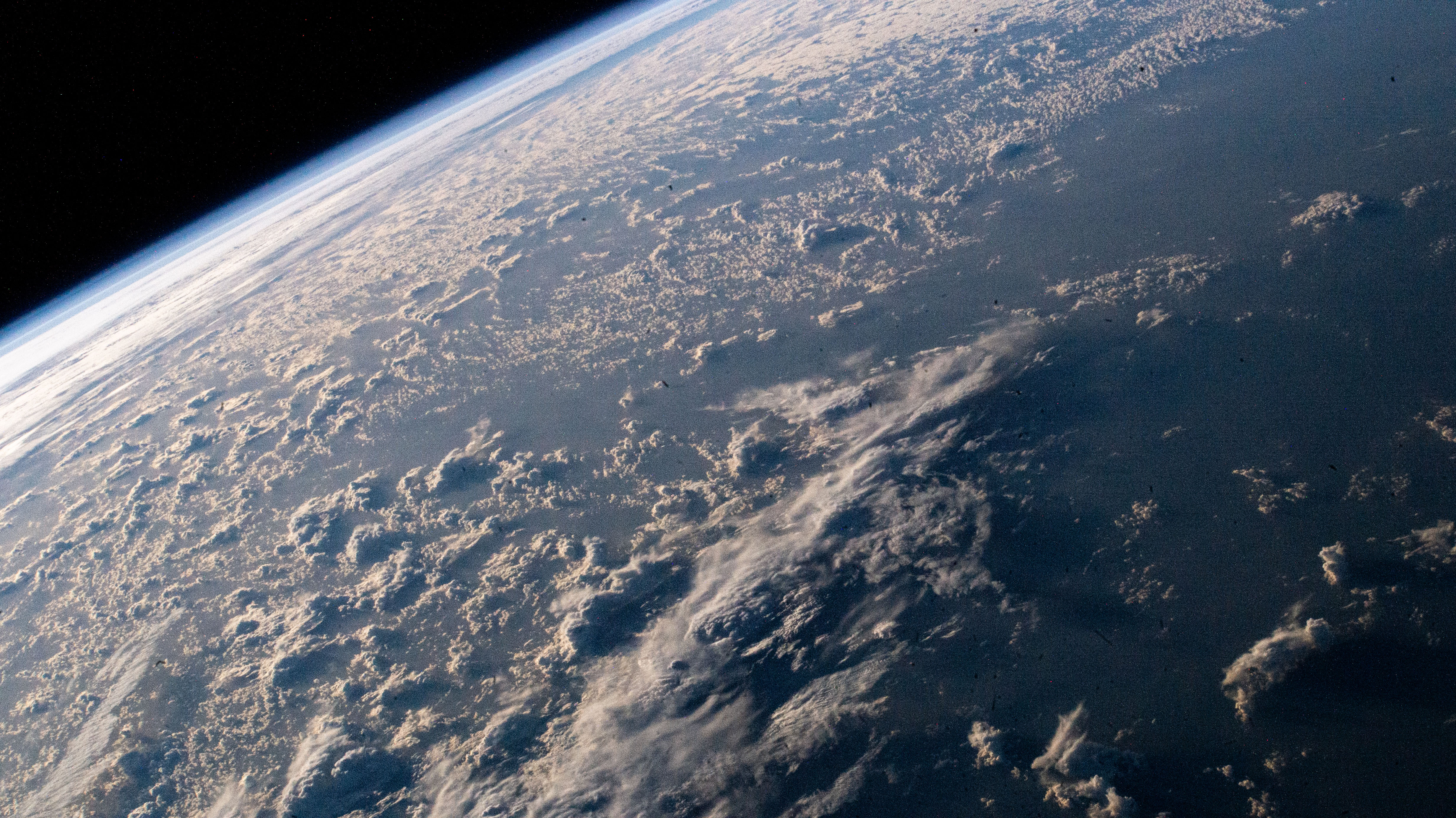 The cloud tops are illuminated just after an orbital sunrise in this photograph from the International Station as it soared 264 miles above the Atlantic Ocean.