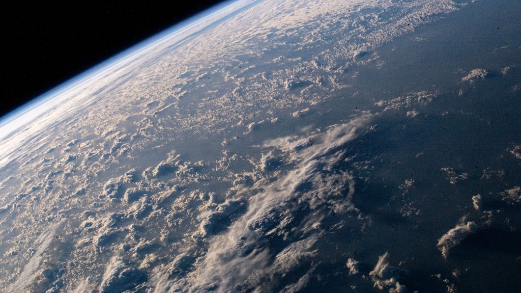 The cloud tops are illuminated just after an orbital sunrise in this photograph from the International Station as it soared 264 miles above the Atlantic Ocean.