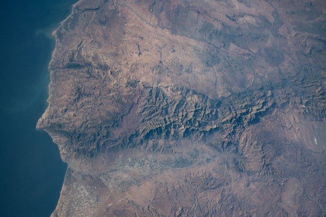 The Atlas Mountain range rises on the Atlantic coast of Morocco and extends east to the North African nations of Algeria and Tunisia. The International Space Station was orbiting 258 miles above the Moroccan coast at the time of this photograph.
