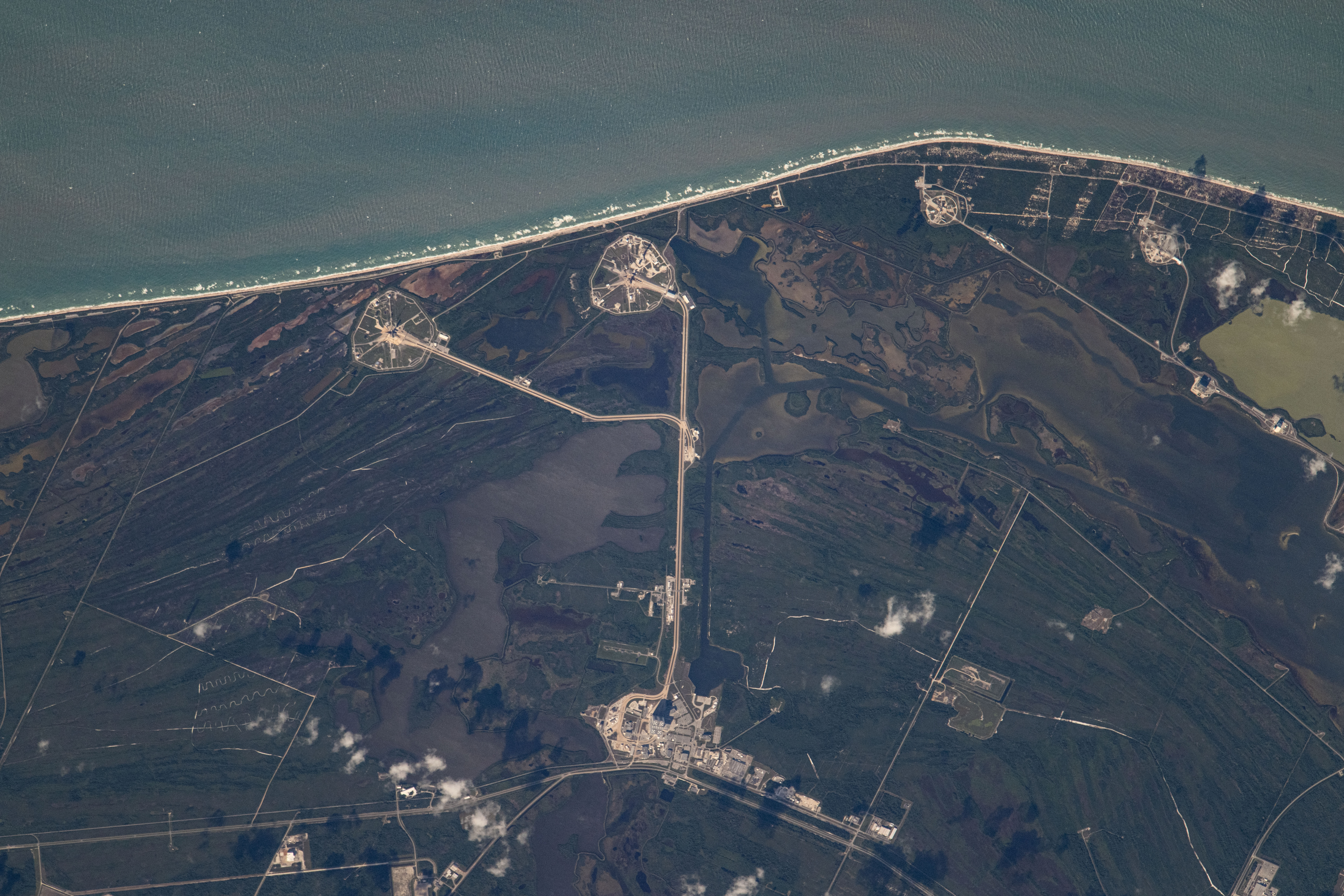 Kennedy Space Center's Launch Pads 39A and 39B on Florida's Merritt Island are clearly visible in this photograph from the International Space Station as it orbited 259 miles above the Atlantic Ocean.