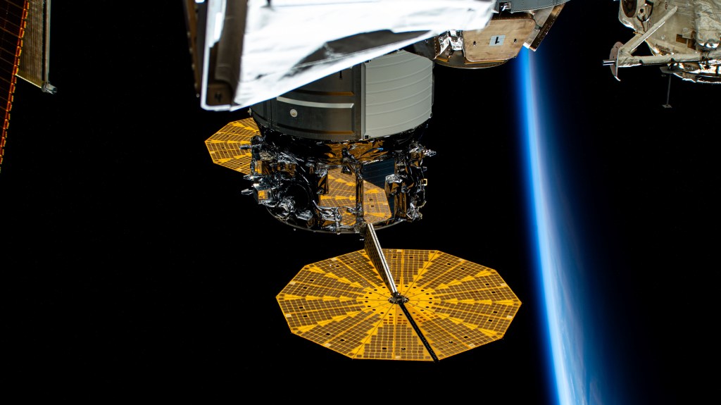 The cymbal-shaped UltraFlex solar arrays that power Northrop Grumman's Cygnus space freighter are featured prominently in this photograph as the International Space Station soared into an orbital sunset 259 miles above western Mongolia.
