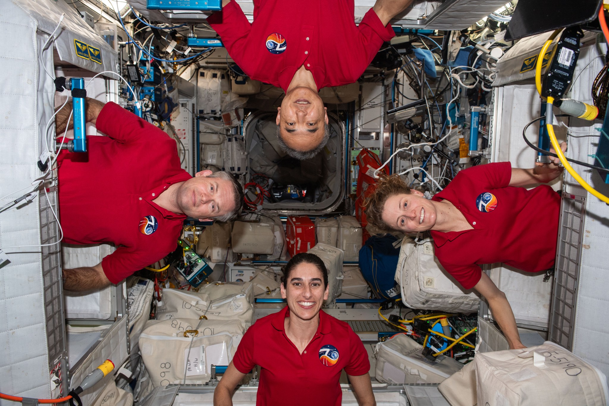 4 Astronauts on the ISS in red shirts