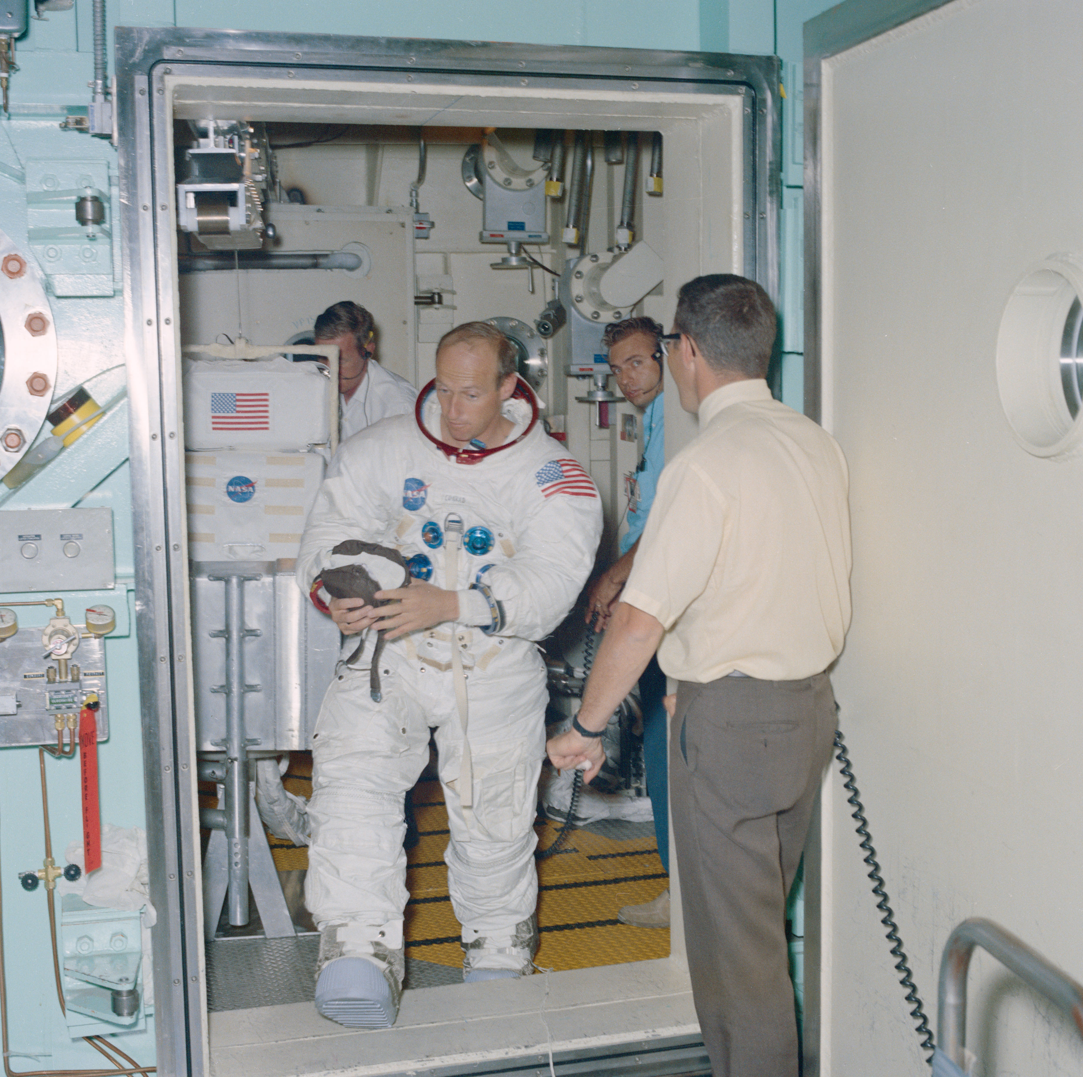 At the Manned Spacecraft Center, now NASA’s Johnson Space Center in Houston, Apollo 12 astronaut Conrad conduct vacuum runs in Chamber B of the Space Environment Simulation Laboratory