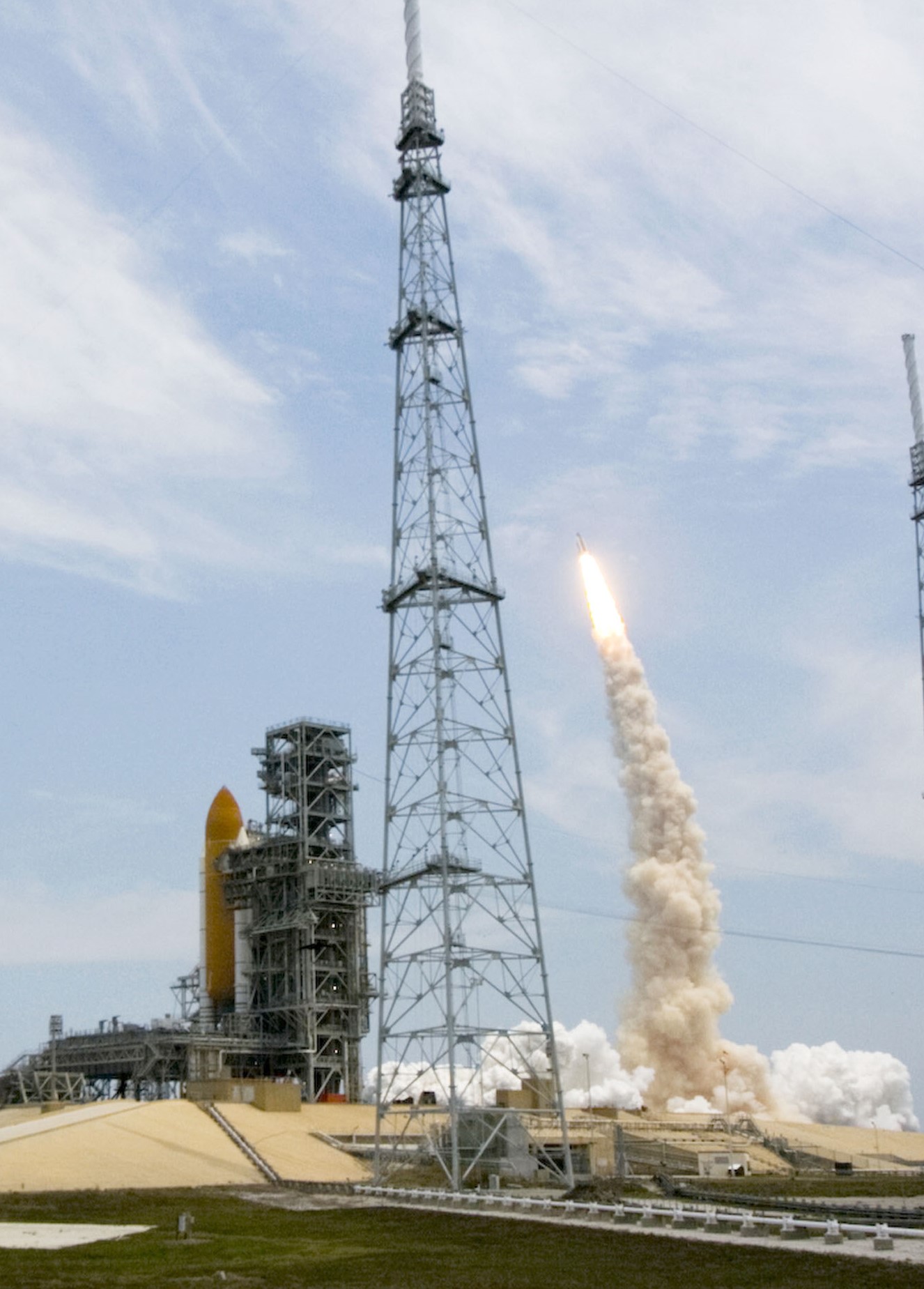 With space shuttle Endeavour in the foreground, space shuttle Atlantis takes off to begin the STS-125 fifth and final Hubble Servicing Mission